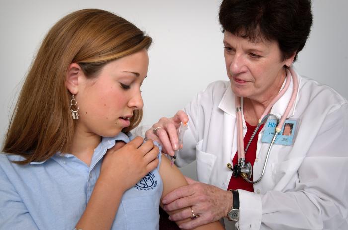 Person receiving a vaccine injection in the shoulder